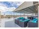 This outdoor patio has covered seating with light blue cushions and an expansive skyline view at 800 N Washington St # 804, Denver, CO 80203