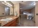 A well-lit bathroom with a sink, vanity, and a view to an upper-level area at 6625 W 84Th Cir # 48, Arvada, CO 80003