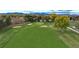 Scenic view of the well-manicured golf course with sand traps and mountain backdrop at 6625 W 84Th Cir # 48, Arvada, CO 80003