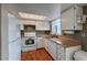 Cozy kitchen features white appliances, wood floors and a charming window at 6625 W 84Th Cir # 48, Arvada, CO 80003