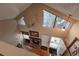 A high angle view of a cozy living room and fireplace, featuring large bright windows at 6625 W 84Th Cir # 48, Arvada, CO 80003