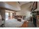 Bright living room with stone fireplace, carpet, and vaulted ceilings at 6625 W 84Th Cir # 48, Arvada, CO 80003