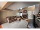 Bright living room boasts a stone fireplace, neutral carpet and a vaulted ceiling at 6625 W 84Th Cir # 48, Arvada, CO 80003