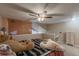 An upstairs main bedroom features a ceiling fan, adjacent loft, and dresser at 6625 W 84Th Cir # 48, Arvada, CO 80003