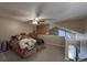 An upstairs main bedroom features a ceiling fan, adjacent loft, and staircase at 6625 W 84Th Cir # 48, Arvada, CO 80003