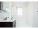 Clean bathroom featuring a vanity with modern faucet and shower over tub at 1735 S Wyandot St, Denver, CO 80223