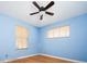 Bright bedroom with hardwood floors, ceiling fan, and two windows at 1735 S Wyandot St, Denver, CO 80223