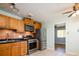 Kitchen featuring stainless steel appliances and convenient access to an adjacent room at 1735 S Wyandot St, Denver, CO 80223