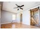 Living room with hardwood floors, ceiling fan, and rustic sliding barn door at 1735 S Wyandot St, Denver, CO 80223
