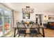 Bright dining area featuring a modern chandelier and sliding door to the backyard at 1271 Uinta St, Denver, CO 80220