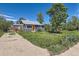 Charming home with a well-maintained lawn and a striking orange front door at 1271 Uinta St, Denver, CO 80220