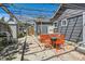 A charming patio area featuring pavers, a metal awning with decorative lighting, and a cozy outdoor dining set at 1271 Uinta St, Denver, CO 80220