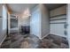 Bathroom with dark brown vanity, storage, and decorative tile flooring at 19347 E 65Th Ave, Aurora, CO 80019