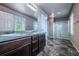 Bathroom features double sinks, granite countertops, tile flooring and a glass-enclosed shower at 19347 E 65Th Ave, Aurora, CO 80019