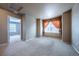 Comfortable bedroom space with ample natural light and neutral-toned walls and carpets at 19347 E 65Th Ave, Aurora, CO 80019