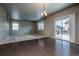 Bright dining room with hardwood floors, sliding glass doors to the deck, and backyard views at 19347 E 65Th Ave, Aurora, CO 80019