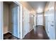 Inviting entryway features hardwood floors and multiple white doors leading to other rooms of the house at 19347 E 65Th Ave, Aurora, CO 80019
