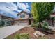 Inviting two-story home with a three car garage, stone accents, and mature landscaping at 19347 E 65Th Ave, Aurora, CO 80019