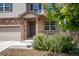 Charming front entry with stone accents, a covered porch, and manicured landscaping offers curb appeal at 19347 E 65Th Ave, Aurora, CO 80019