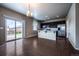 Open kitchen with stainless appliances flowing into the dining area and walkout deck at 19347 E 65Th Ave, Aurora, CO 80019