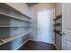 Walk-in pantry with shelving and hardwood floors for ample storage at 19347 E 65Th Ave, Aurora, CO 80019