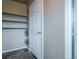 Walk-in storage with shelving, a white door, and neutral walls at 19347 E 65Th Ave, Aurora, CO 80019