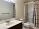 Neutral bathroom with vanity, toilet, and shower/tub combo with shower curtain at 8430 Little Rock Way # 102, Highlands Ranch, CO 80126