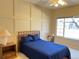 Bedroom with a blue bed, ceiling fan, lamp, and window at 8430 Little Rock Way # 102, Highlands Ranch, CO 80126