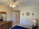 Bedroom with a bed, ceiling fan, dresser with mirror, and closet at 8430 Little Rock Way # 102, Highlands Ranch, CO 80126