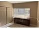 Bedroom featuring a dresser, multiple closets with sliding doors, and natural light at 8430 Little Rock Way # 102, Highlands Ranch, CO 80126
