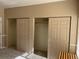 Bedroom showcasing two closets with sliding doors and ample storage space at 8430 Little Rock Way # 102, Highlands Ranch, CO 80126