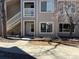 Inviting two-story condo featuring exterior staircase, large windows and landscaping at 8430 Little Rock Way # 102, Highlands Ranch, CO 80126