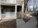 Exterior showcases stairs and balcony, complemented by a sidewalk and lush landscaping at 8430 Little Rock Way # 102, Highlands Ranch, CO 80126