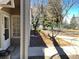 Inviting entryway with white trim and a glimpse of the landscaped surroundings and sidewalk at 8430 Little Rock Way # 102, Highlands Ranch, CO 80126