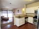 Bright kitchen with a breakfast bar, stainless steel appliances, and an open layout to the living area at 8430 Little Rock Way # 102, Highlands Ranch, CO 80126