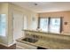 Updated kitchen with a breakfast bar featuring granite countertops, white cabinets, and stainless steel appliances at 8430 Little Rock Way # 102, Highlands Ranch, CO 80126