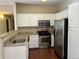 Updated kitchen featuring stainless steel appliances, granite countertops, and white cabinetry at 8430 Little Rock Way # 102, Highlands Ranch, CO 80126