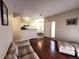 Open concept living space with hardwood floors connecting the living room to the updated kitchen at 8430 Little Rock Way # 102, Highlands Ranch, CO 80126