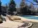 Community pool features a bench for lounging, a quaint bridge, and lush surroundings at 8430 Little Rock Way # 102, Highlands Ranch, CO 80126