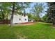 Large backyard offering a mix of lawn, mulch beds, and mature trees, providing a serene outdoor space at 11880 W 30Th Pl, Lakewood, CO 80215
