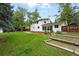 Expansive backyard with a manicured lawn, privacy fence, and inviting garden area, perfect for relaxation at 11880 W 30Th Pl, Lakewood, CO 80215