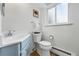 Cozy half-bathroom with modern sink and toilet at 11880 W 30Th Pl, Lakewood, CO 80215