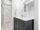Modern bathroom boasts a sleek dark vanity with a white countertop and stylish fixtures, plus tiled floors at 11880 W 30Th Pl, Lakewood, CO 80215