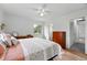 Spacious bedroom with hardwood floors, ceiling fan, and en-suite bathroom access at 11880 W 30Th Pl, Lakewood, CO 80215