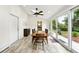 Bright dining room with tile floors, skylights, a ceiling fan, and sliding doors to the outside at 11880 W 30Th Pl, Lakewood, CO 80215