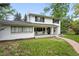 Attractive two-story home with a bright white exterior, well-maintained lawn, and a charming front porch at 11880 W 30Th Pl, Lakewood, CO 80215