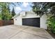 Detached two-car garage with a black door and basketball hoop, offering ample parking and recreational space at 11880 W 30Th Pl, Lakewood, CO 80215