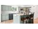 Modern kitchen featuring updated appliances, ample counter space, a breakfast bar, and stylish decor at 11880 W 30Th Pl, Lakewood, CO 80215
