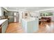 Open concept kitchen with island, hardwood floors, and a seamless flow to the living area at 11880 W 30Th Pl, Lakewood, CO 80215