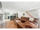 Bright living space featuring hardwood floors, a staircase, and a kitchen view, creating an inviting atmosphere at 11880 W 30Th Pl, Lakewood, CO 80215